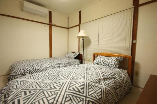 Katil atau katil-katil dalam bilik di 札幌ドーム前ハウス Sapporodome front house