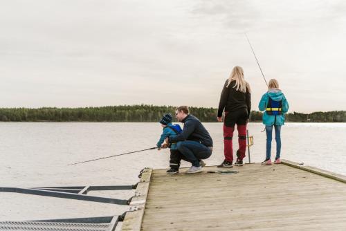 a group of people fishing on a dock at First Camp Duse Udde - Säffle in Säffle