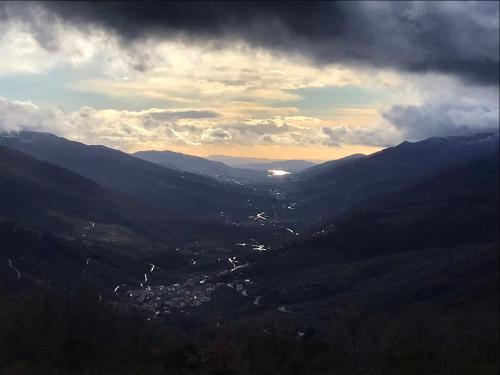 a view of a valley in the mountains with a city at LA GARGANTILLA in Jerte