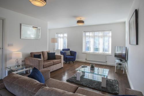a living room with a couch and a table at Vale House in Northfleet