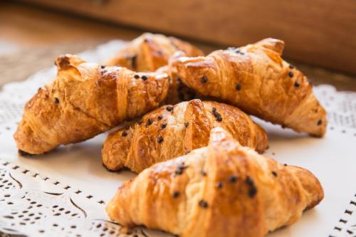 a pile of pastries sitting on a plate at Hotel Mas Bosch 1526 in Avinyonet de Puigventós