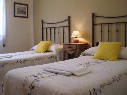 a bedroom with two beds with towels on them at Casa Rural Las Tuyas en Segovia in Palazuelos de Eresma