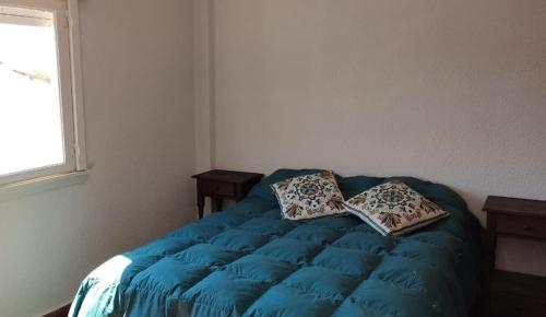 Una cama o camas en una habitación de Frente Al Mar - La Lucila