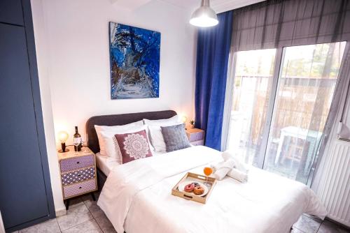 a bedroom with a bed with a tray of fruit on it at Lux apartment downtown in Serres