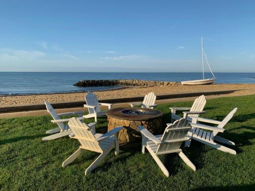 a group of chairs and a table with a fire pit at Lighthouse Inn Cape Cod in West Dennis