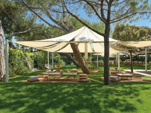 a large white tent sitting in a grass field at Augustus Hotel & Resort in Forte dei Marmi