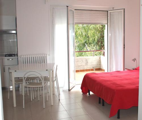 uma cozinha e sala de jantar com uma mesa e uma cama em Residenza Abbo em Diano Marina