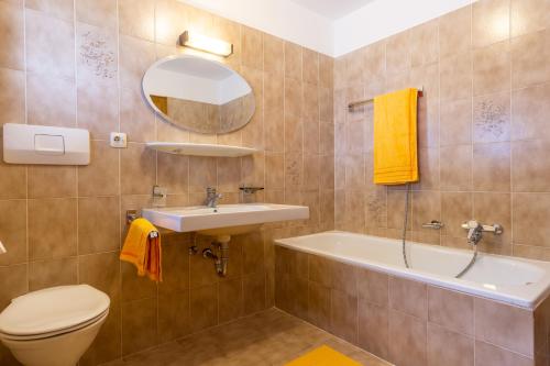 a bathroom with a sink and a toilet and a mirror at Home in the Alps in Racines