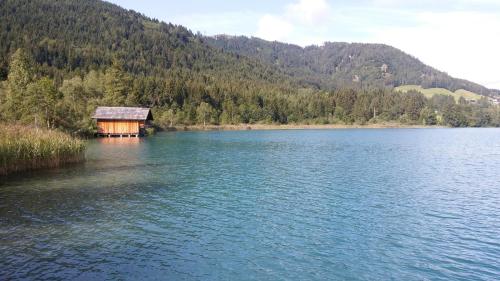 a cabin in the middle of a large lake at Haus Birke in Weissensee