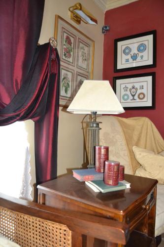 a room with a table with a lamp on it at Palazzo Muro Leccese Relais de Charme & Wellness in Muro Leccese