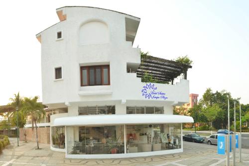 a white building with a store in front of it at Hotel Suites Ixtapa Plaza in Ixtapa