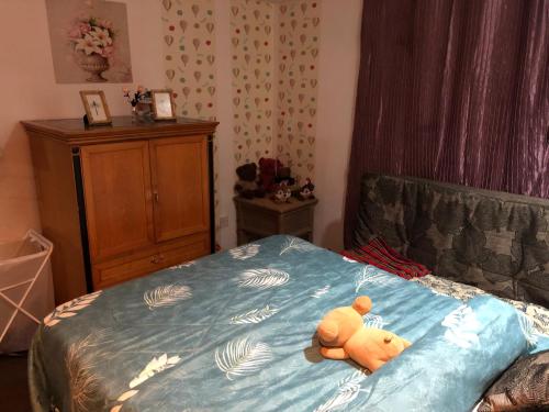 a teddy bear laying on top of a bed at Mieqa@TheRegencyTanjungTuan (seafront unit) in Port Dickson