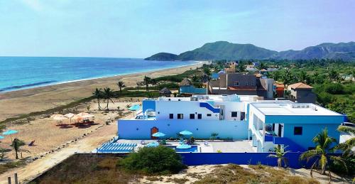 a house on the beach next to the ocean at Villa Star of the Sea in Barra de Navidad