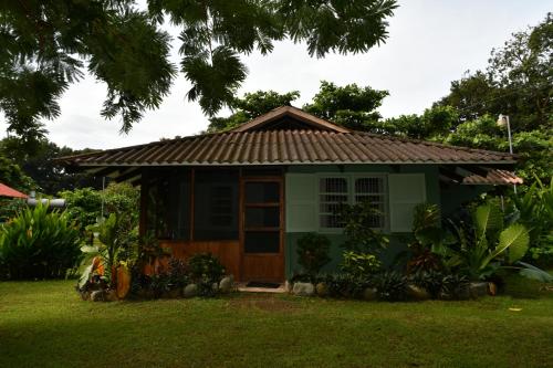 a small green house with a brown roof at Hacienda Baru in Dominical