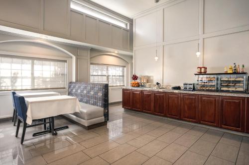 a large kitchen with a table and a counter at Radisson Hotel Salt Lake City Airport in Salt Lake City