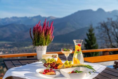 a table with a plate of food and a drink at Butorowy Dwór in Kościelisko