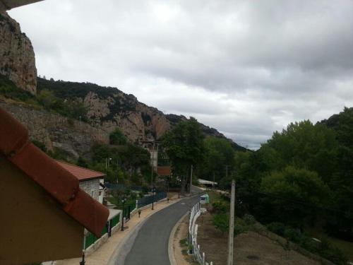 a winding road in a mountain village with trees at Hotel Durtzi in Sobrón