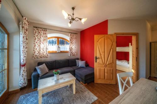 a living room with a couch and a table at Butorowy Dwór in Kościelisko