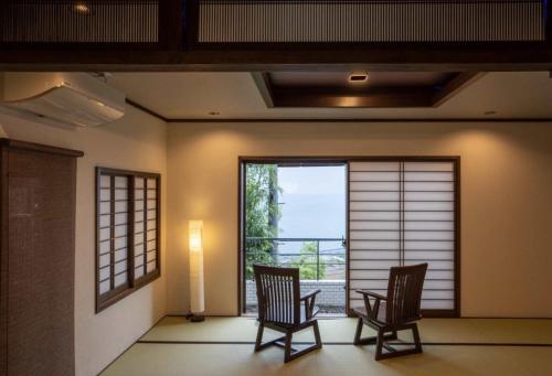 a room with two chairs and a large window at Atami - Hotel / Vacation STAY 56914 in Atami