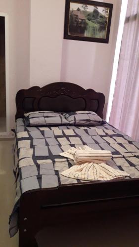 a bed in a bedroom with a bedspread on it at Keba in Tbilisi City
