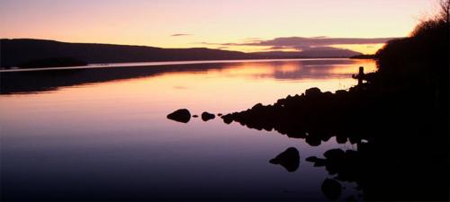 a view of a body of water with a sunset at The Willows at Mullans Bay in Kesh
