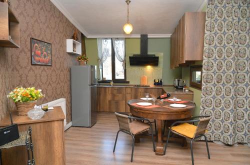 a kitchen and dining room with a table and chairs at Natia's apartment on Dadiani st. in Tbilisi City