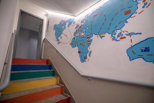 a wall with a map of the world on it at America Del Sur Hostel Buenos Aires in Buenos Aires