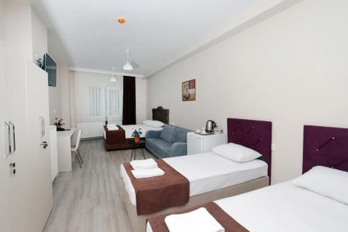 Postel nebo postele na pokoji v ubytování BEKSİTİ HOTEL
