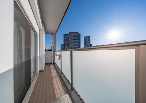 a balcony of a building with a view of the city at Meet Me Umeda Nishi in Osaka