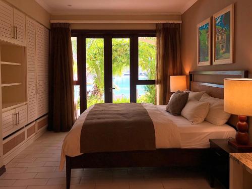 a bedroom with a large bed and a large window at Eden Island Apartment - P14A3 in Eden Island
