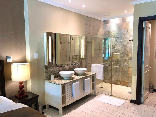 a bathroom with two sinks and a shower at Eden Island Apartment - P14A3 in Eden Island