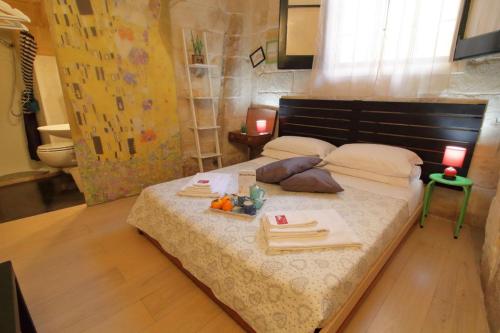 a bedroom with a bed with a tray of food on it at White Suite B&B in Lecce