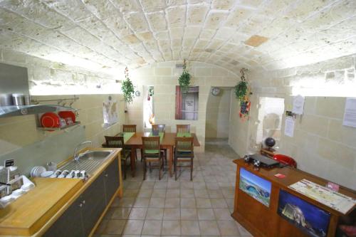 a kitchen with a table and a dining room at White Suite B&B in Lecce
