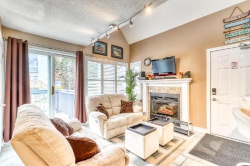 a living room with two chairs and a fireplace at Condo 713 at North Creek Resort in Blue Mountains