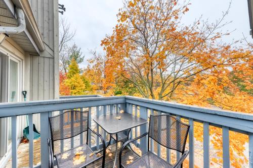 a patio with a table and chairs on a balcony at Condo 214 at North Creek Resort by Vacasa II in Blue Mountains