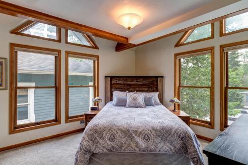 a bedroom with a large bed and windows at Silver Jacks Condo in Breckenridge