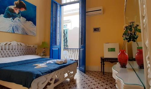 a bedroom with a bed with blue and yellow walls at Balcones Habana Vieja in Havana