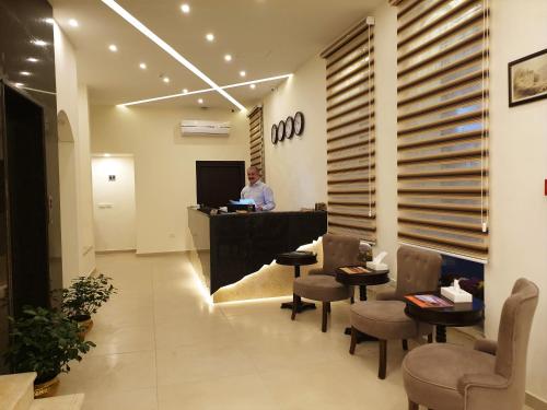 a man standing at the counter of a salon at Petra Heart Hotel in Wadi Musa