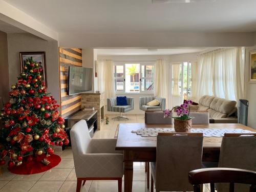 a living room with a christmas tree in it at Recanto da Sol in Florianópolis