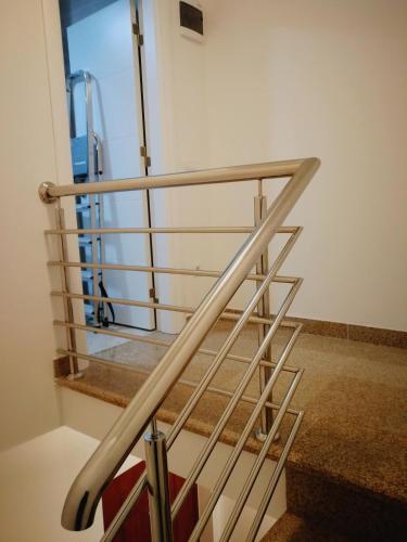 a metal staircase in a room with a window at Vi apartment 1lin of the sea in Bar