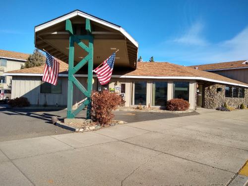 a building with two american flags in front of it at The Wilderness Inn in Enterprise