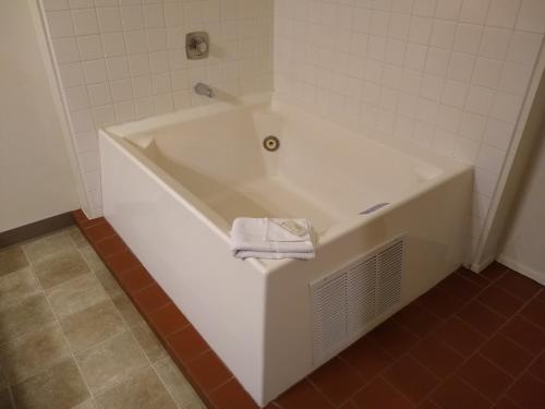a white bath tub in a bathroom with a towel at The Wilderness Inn in Enterprise