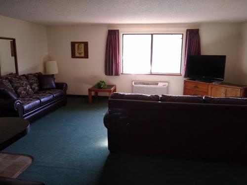 a living room with a couch and a large window at The Wilderness Inn in Enterprise