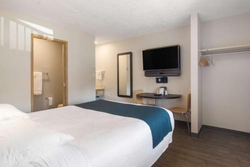 a hotel room with a bed and a flat screen tv at Motel 6-Saanichton, BC - Victoria Airport in Saanichton