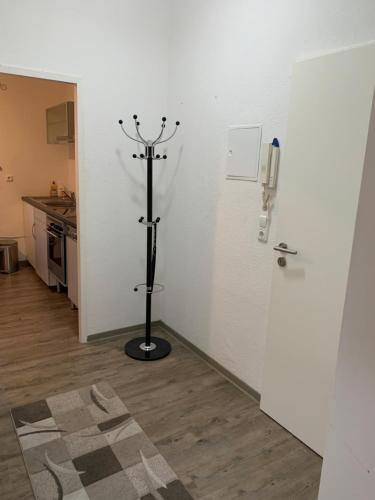 a room with a white wall with a candlestick at Feuerbachstr.9 Ferienwohnung in Bottrop