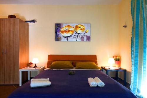 a bedroom with a bed with two towels on it at Lighthouse Apartments in Budva
