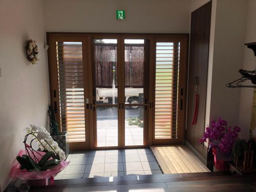 an open door in a room with wooden doors at ゲストハウス奈良庵 Nara An in Nara