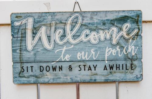 a sign that says welcome to our room sit down and stay awhile at House-Canyon Dr in Oceanview