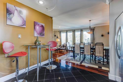 a dining room with red chairs and a table at House-Canyon Dr in Oceanview