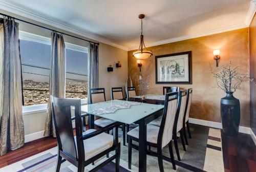 a dining room with a table and chairs and a window at House-Canyon Dr in Oceanview